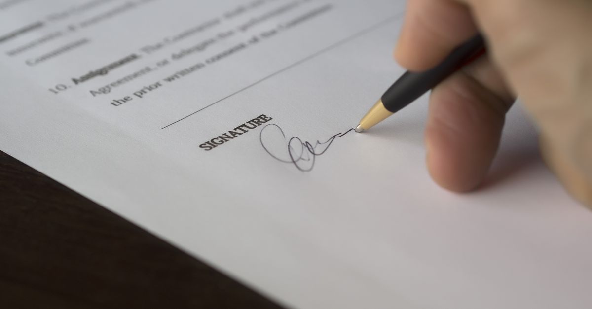 A contract being reviewed and signed