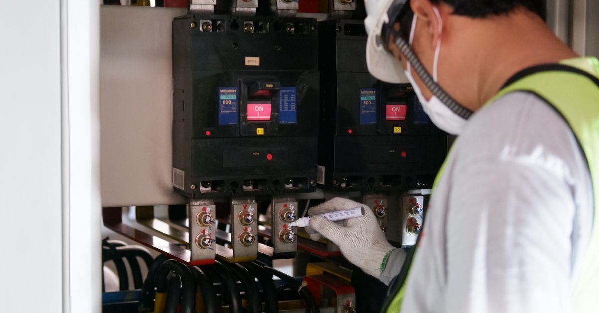 An inspector checking a breaker panel
