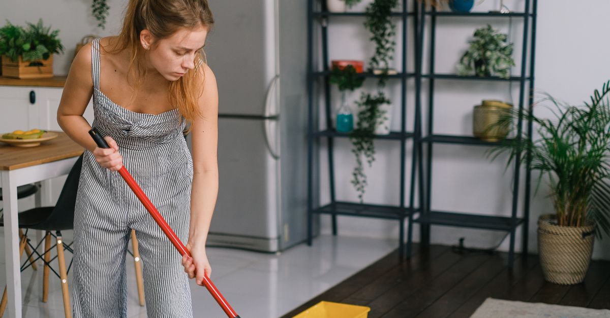 A mop and bucket on a tile floor