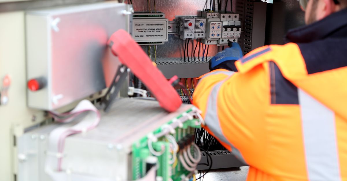 An inspector checking a breaker panel