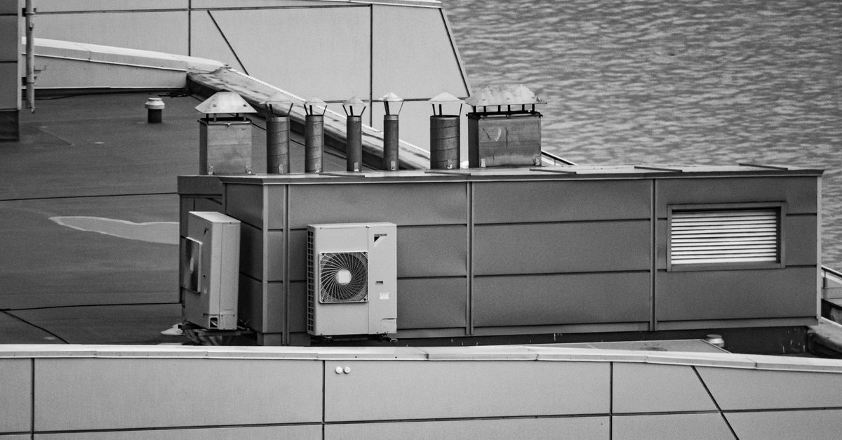 A crane lifting an AC unit