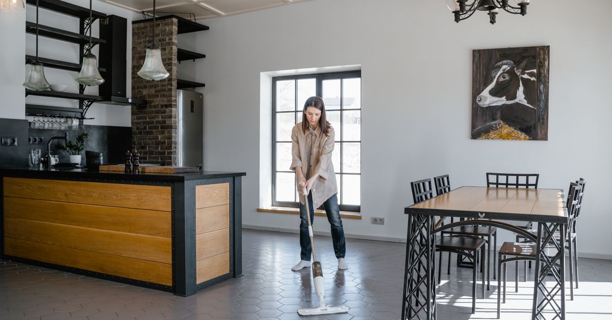 A mop and bucket on a tile floor
