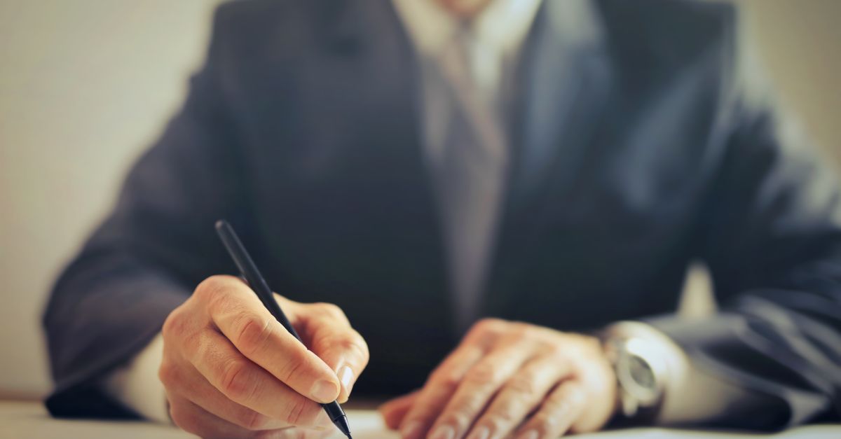 A homeowner signing a construction contract