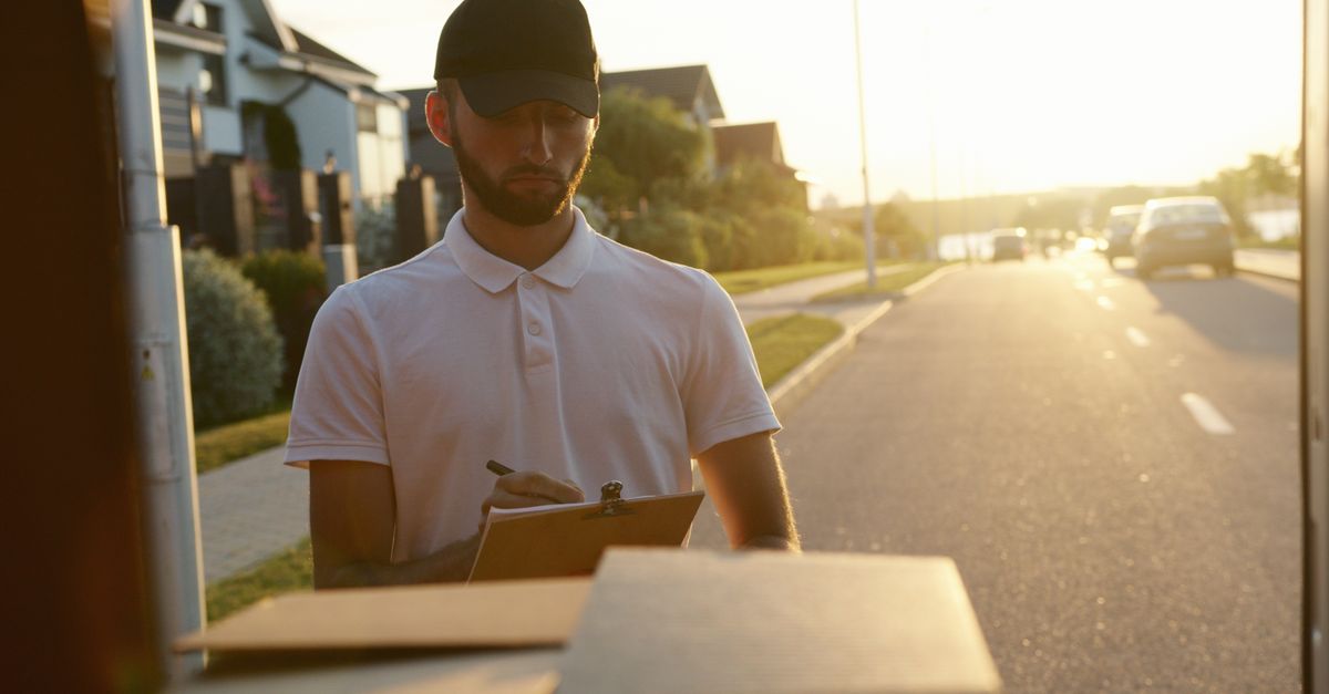 A person at a front door with a clipboard