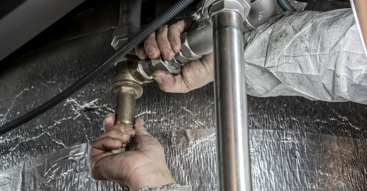 A plumber repairing pipes