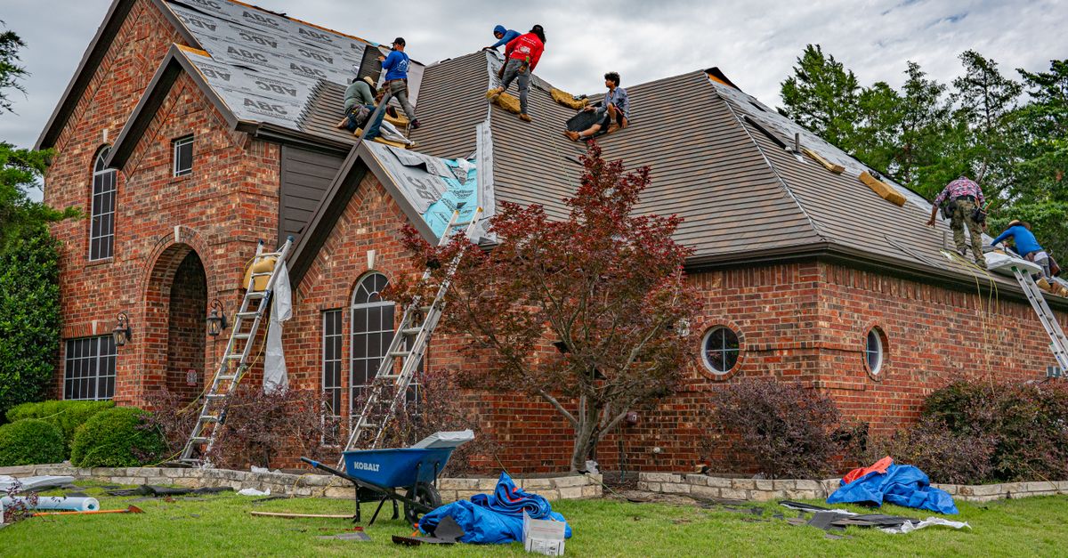A roofer at work on a residential roof
