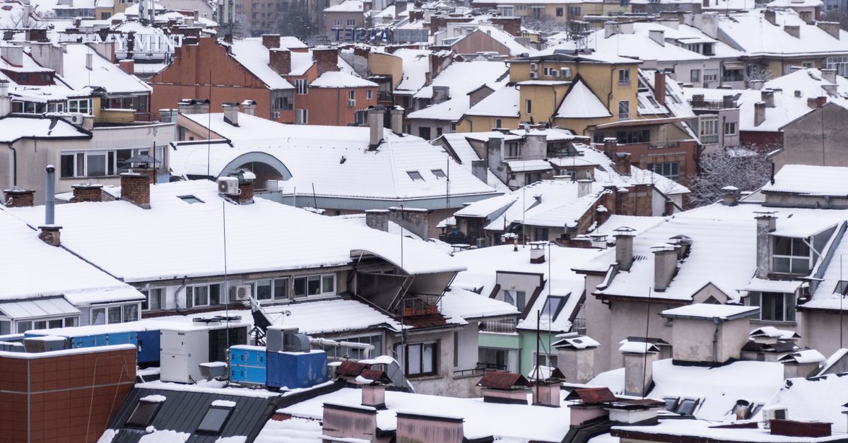 A snow-loaded roof on a winter home