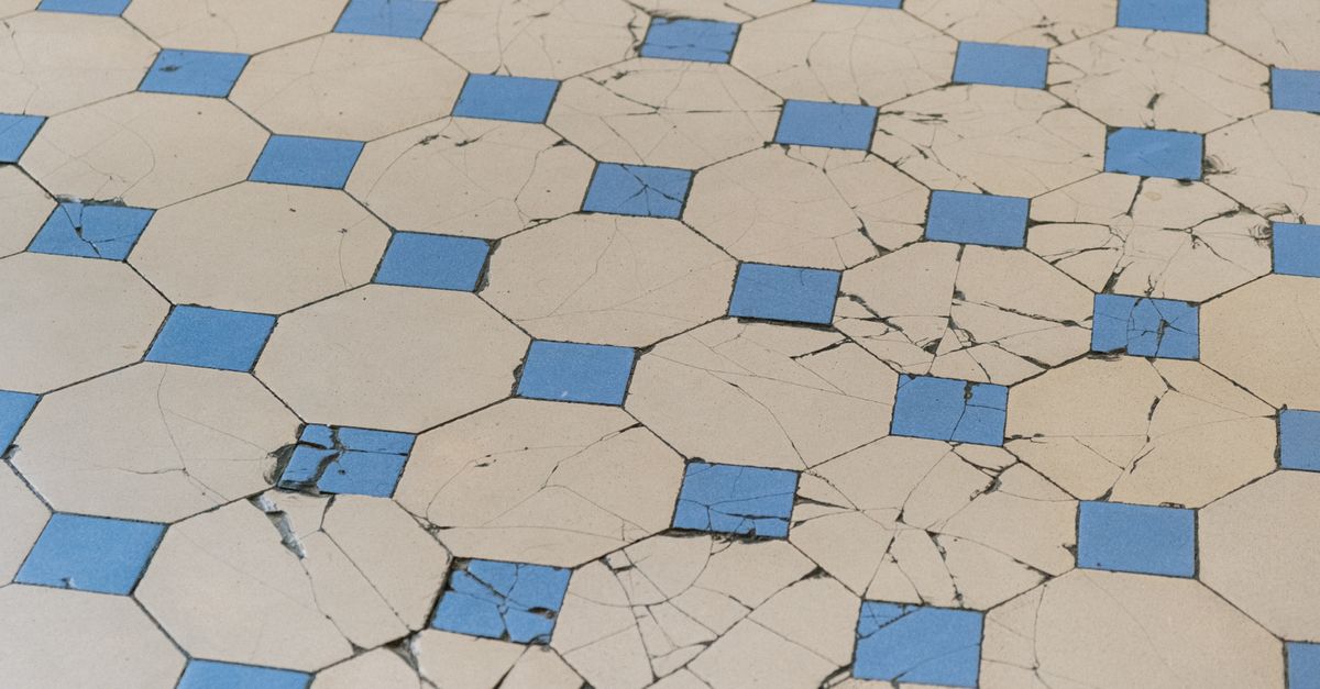 A cracked and chipped floor tile