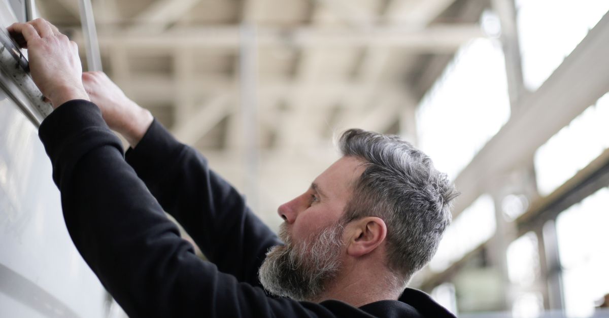 A garage door technician inspecting a door