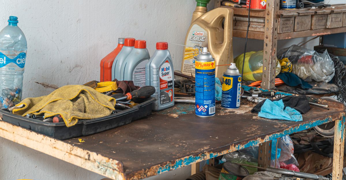 A garage door track and roller being serviced