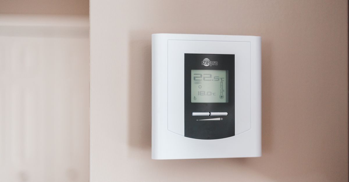A smart thermostat on a wall