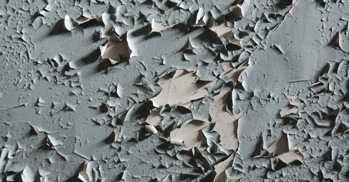 Peeling and cracked paint on an exterior wall