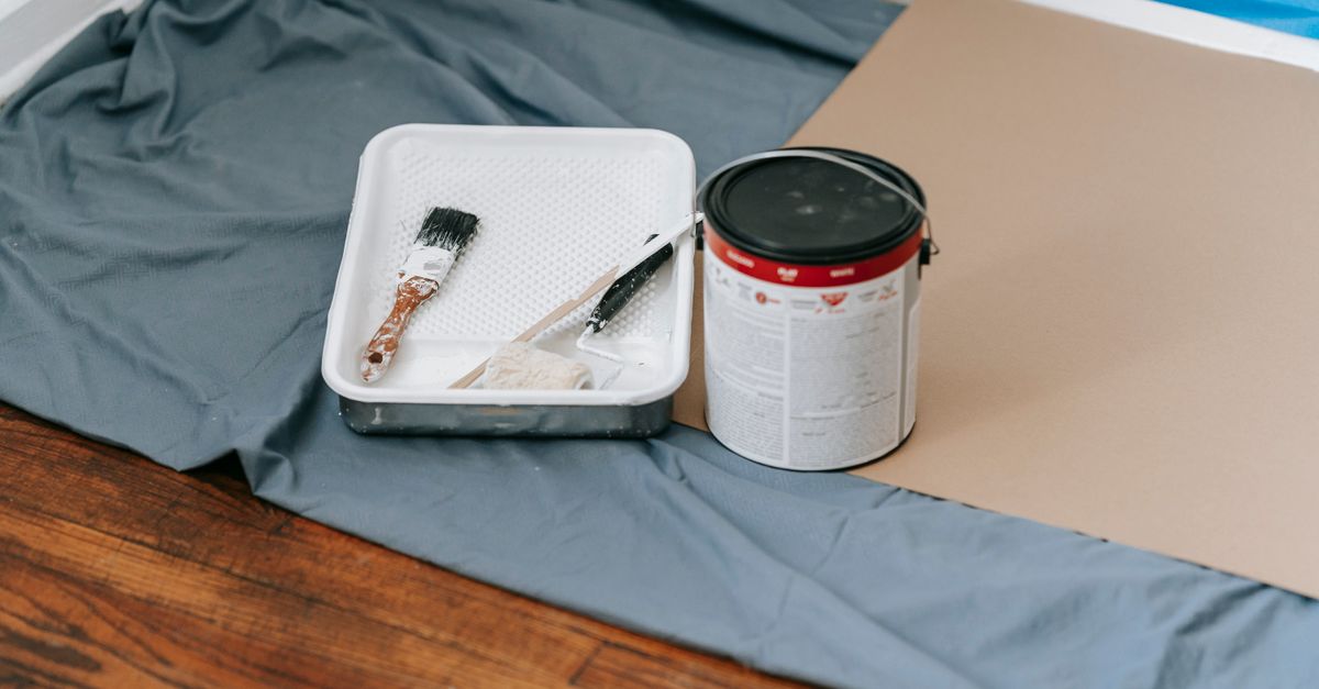 A room prepped for painting with drop cloths and tape