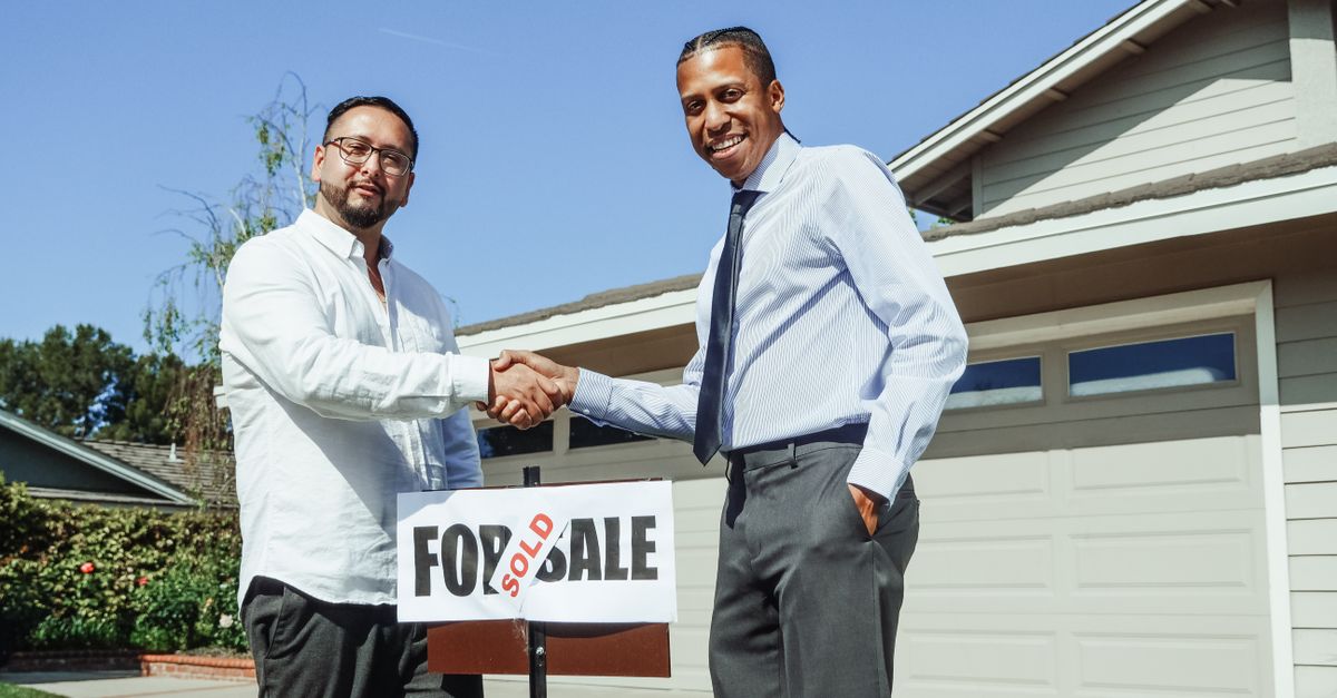 A homeowner shaking hands with a contractor