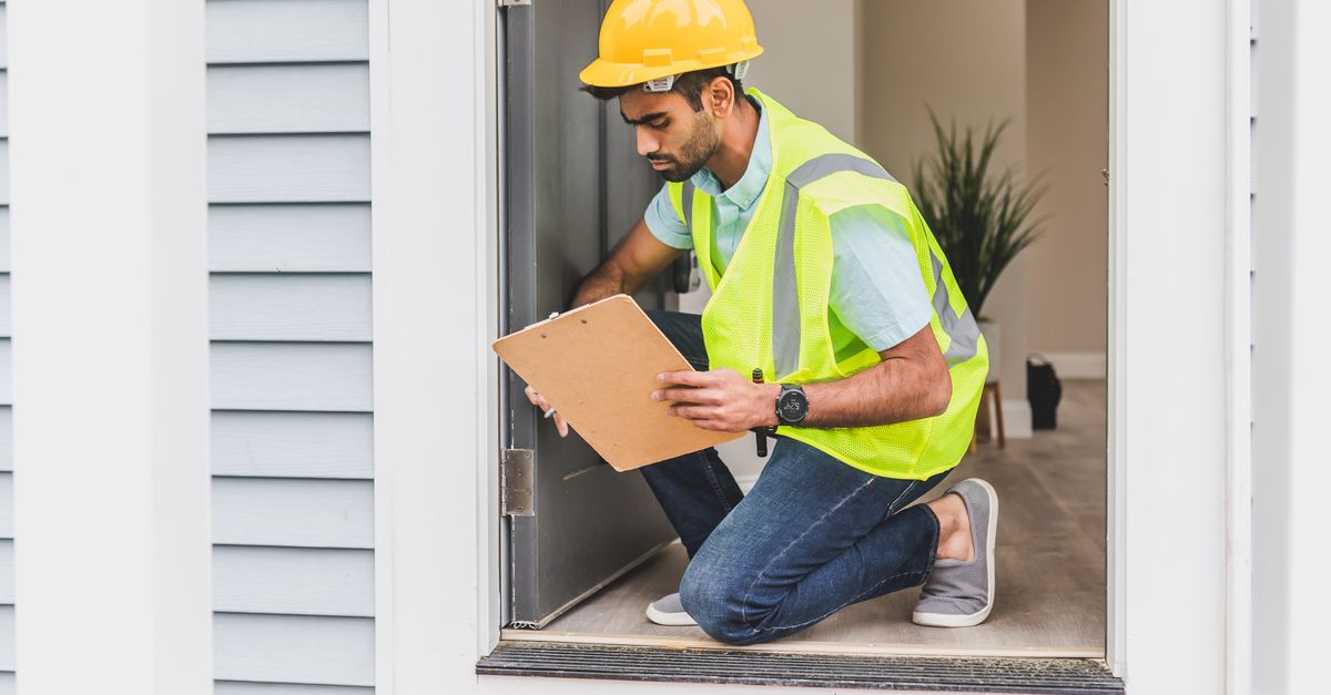 A pest control technician discussing findings with a homeowner