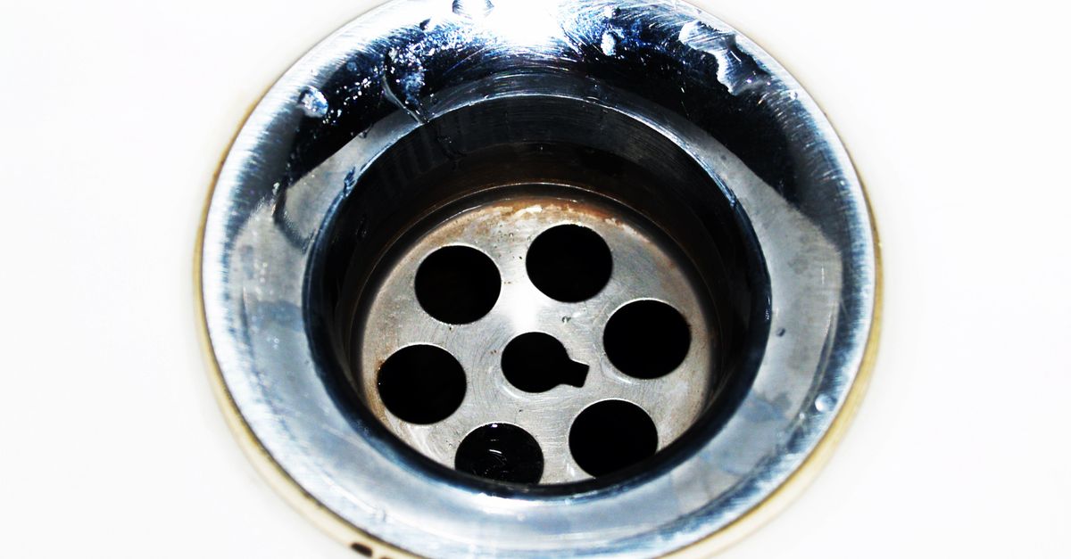 A plumber clearing a drain line