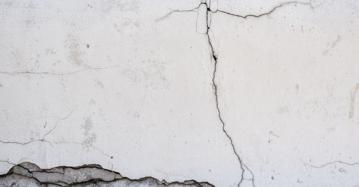 A crack in a pool deck or shell