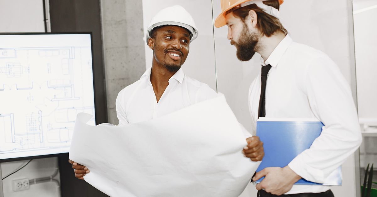 A homeowner and contractor discussing a backyard project
