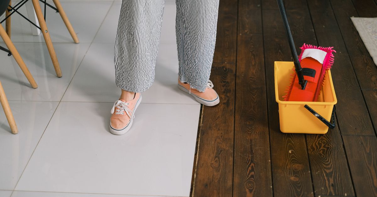 A tile floor being mopped and cleaned