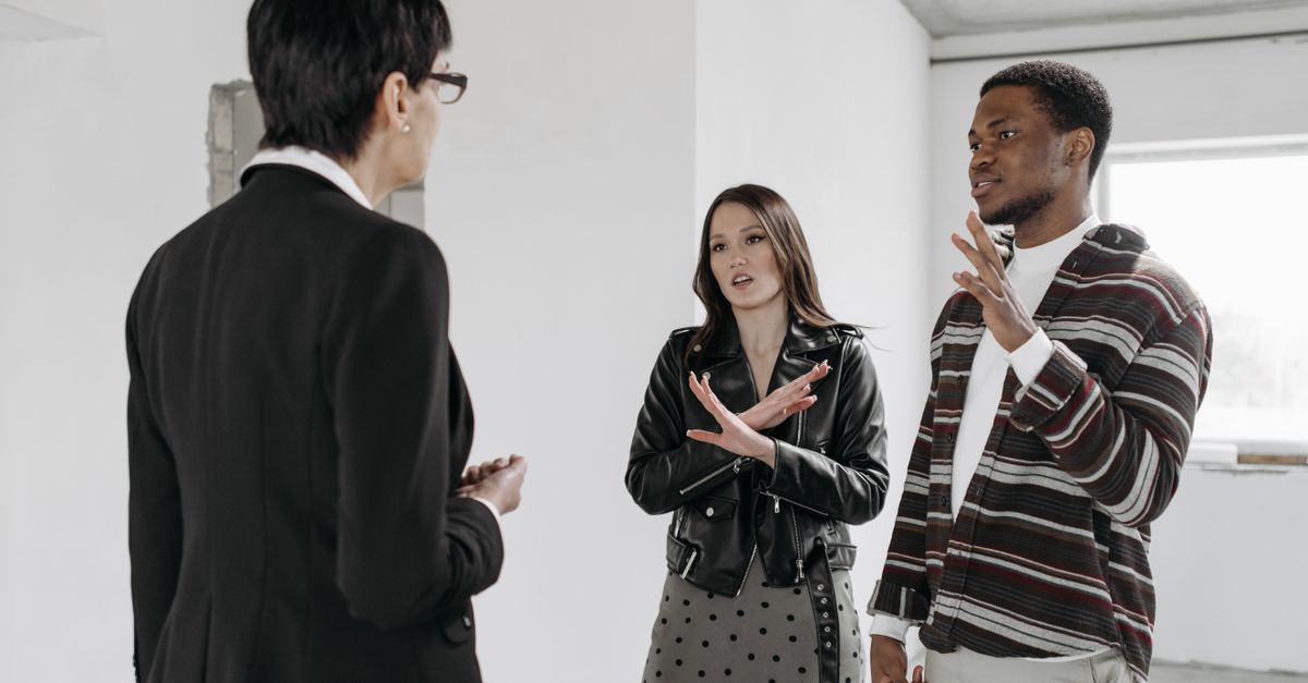 A homeowner talking with a cleaning professional