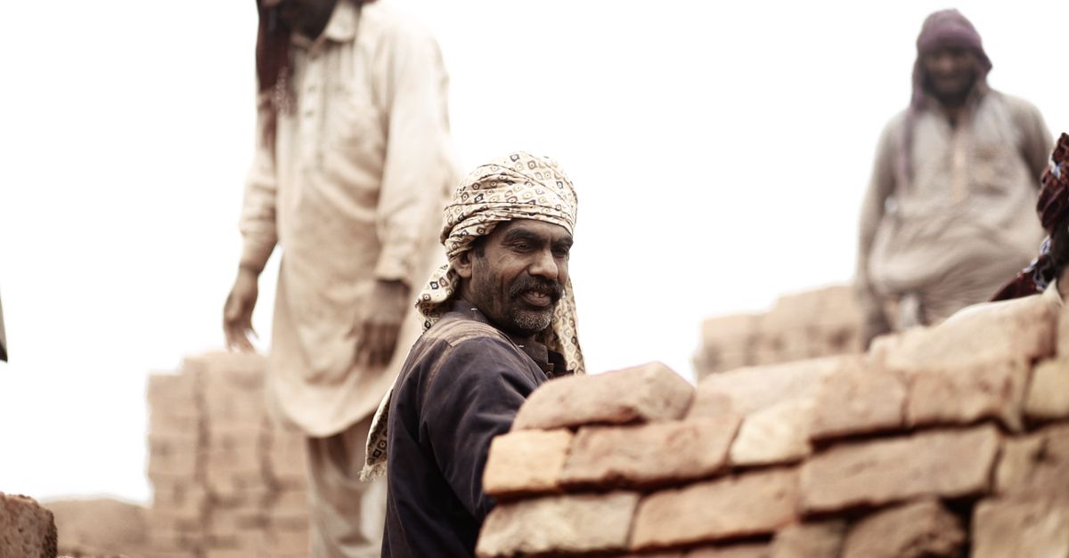 A mason laying brick on a project