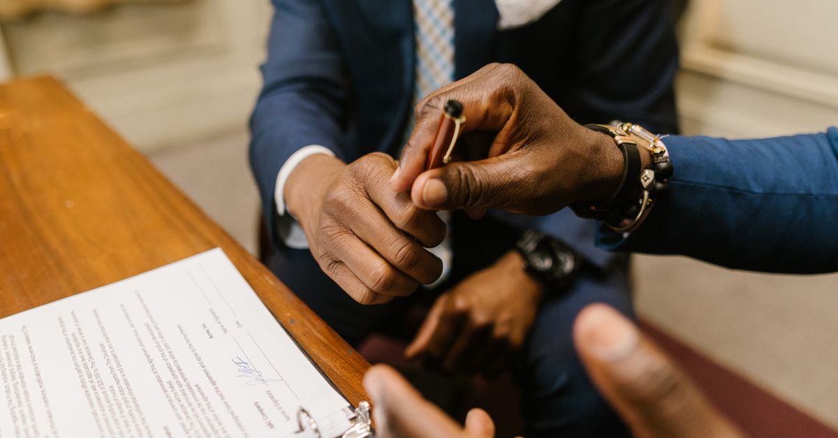 A homeowner signing a construction contract