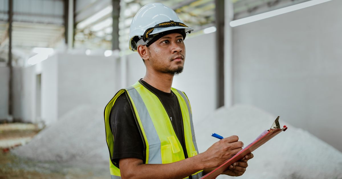 A contractor reviewing an estimate on a clipboard