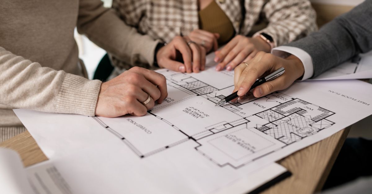 A landscaper discussing plans with a homeowner