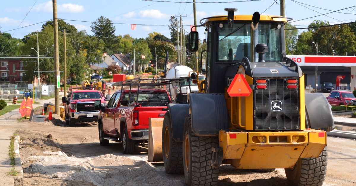 A landscaping crew and truck at a job