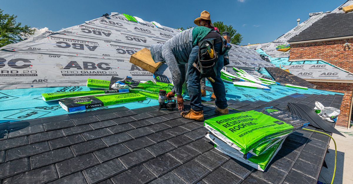 A roofer reviewing an estimate with a homeowner