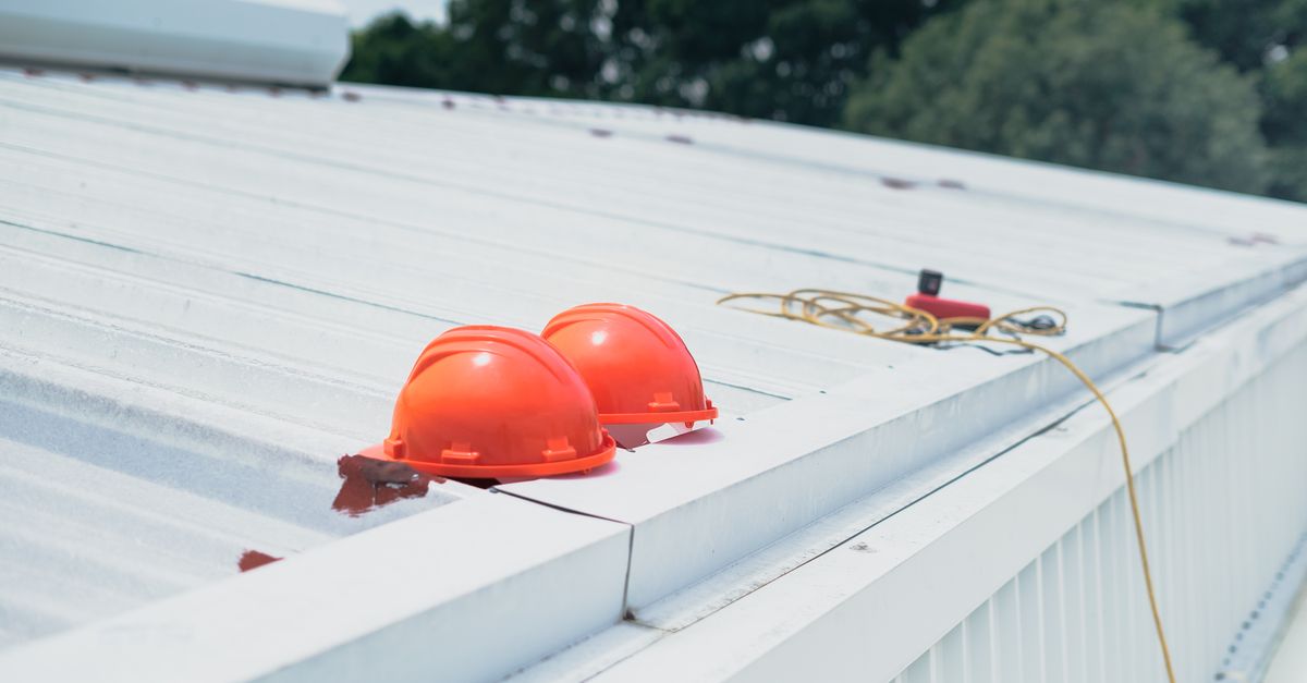 A roof being inspected from a ladder