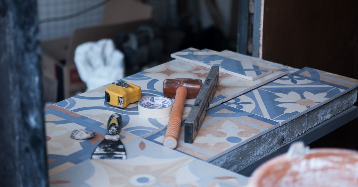 Tile flooring being installed in a kitchen