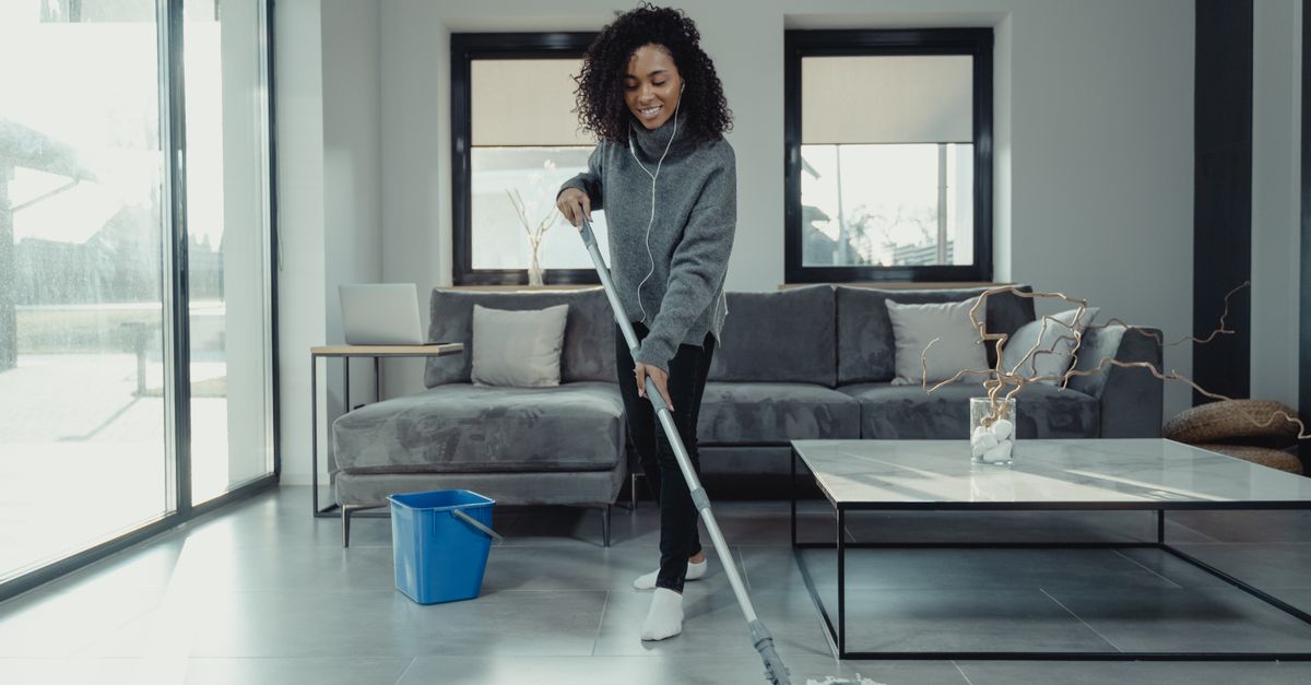 A tile floor being mopped and cleaned